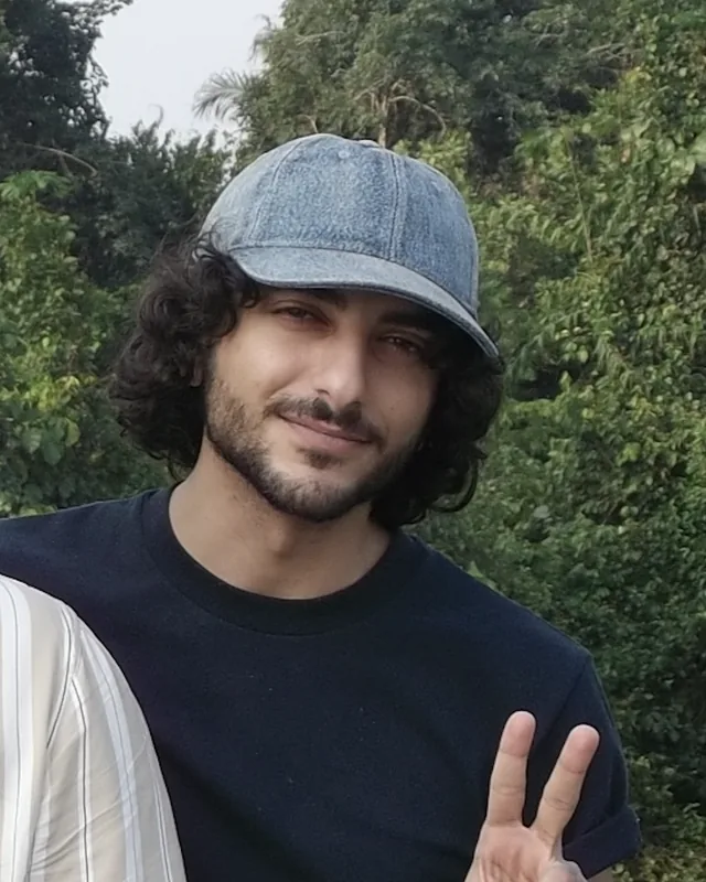 Mohammad Ashraf, smiling, in a denim cap, outdoors